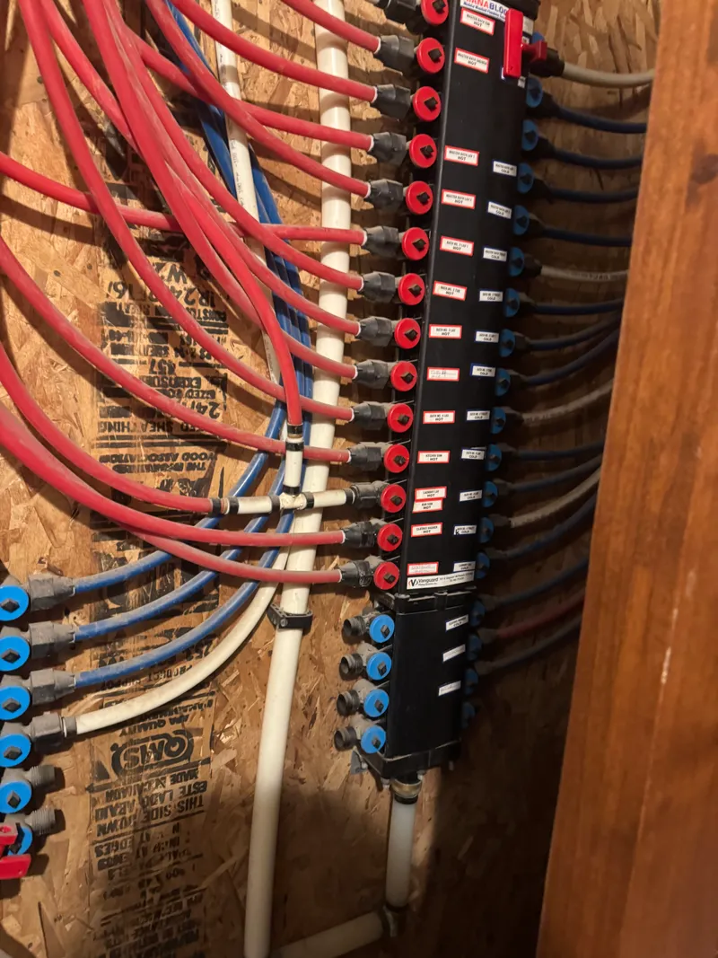 PEX manifold system with organized red and blue water lines