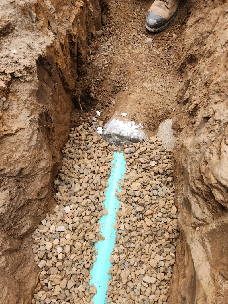 New PVC sewer pipe bedded in drainage gravel
