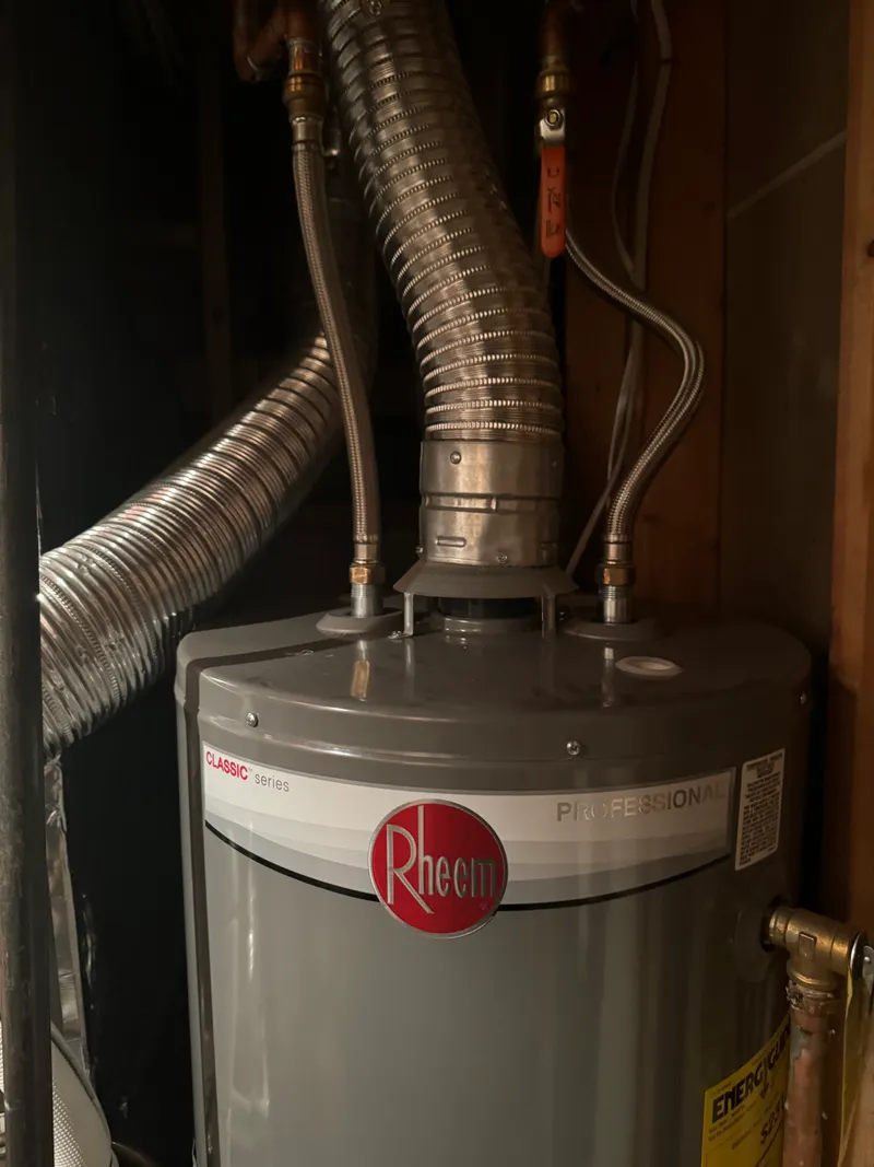 Old water heater removed from a Northern Utah home showing sediment and hard water scale damage